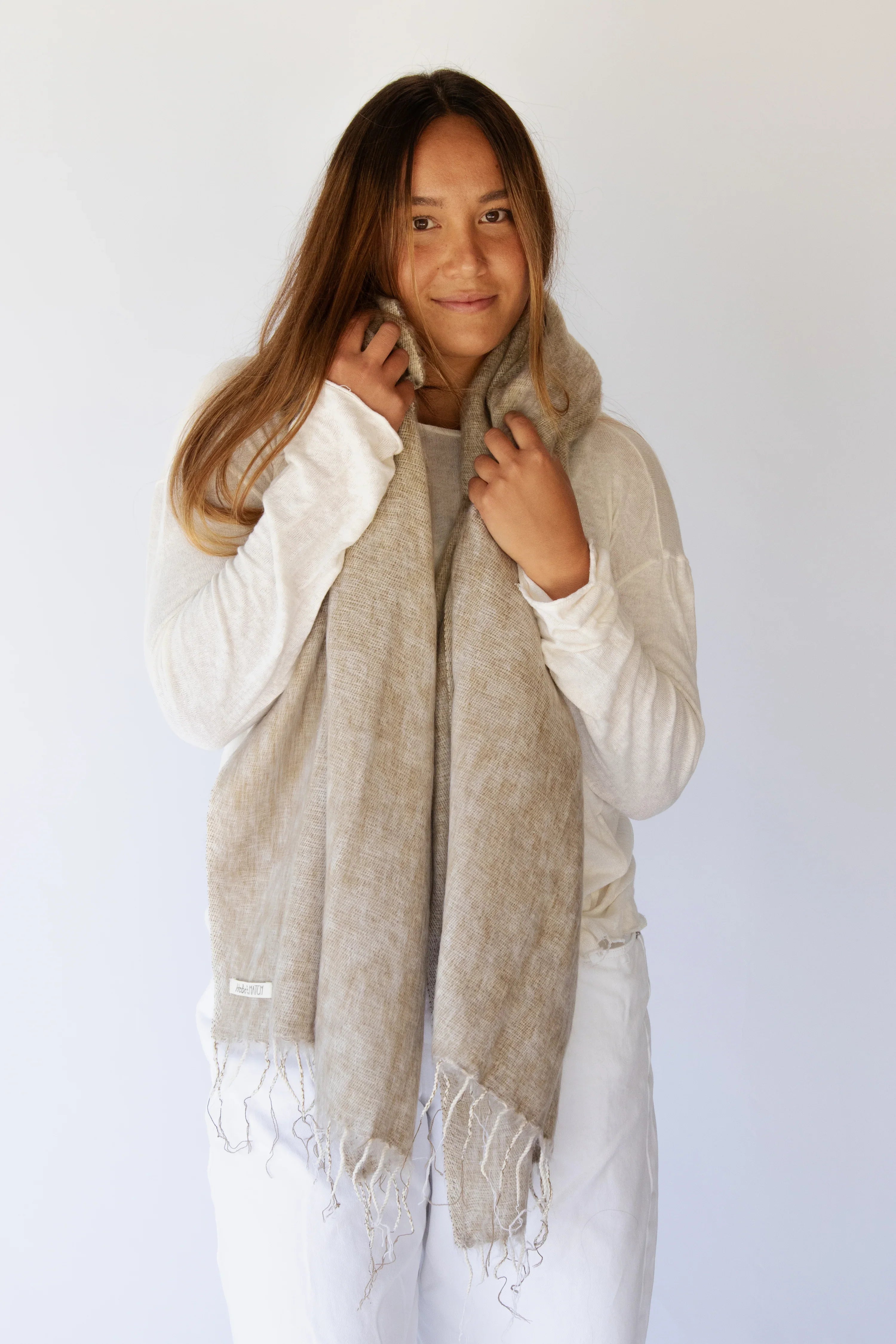 Meet the layer you’ll reach for repeatedly. Worn as a shawl, wrap or scarf, this timeless piece moves effortlessly from slow mornings to cool evenings. Cosy yet refined, it’s made for early yoga flows, windswept beach sunsets, and everything in between.

Lightweight but warming, it’s the ultimate travel companion - wrapping you in comfort and that familiar, at-home feeling wherever you land.

Available in: Mulberry &amp; Hazelnut.

Details
• Approx. 76cm x 188cm
• Cool hand-wash, dry with care
• Handwoven i