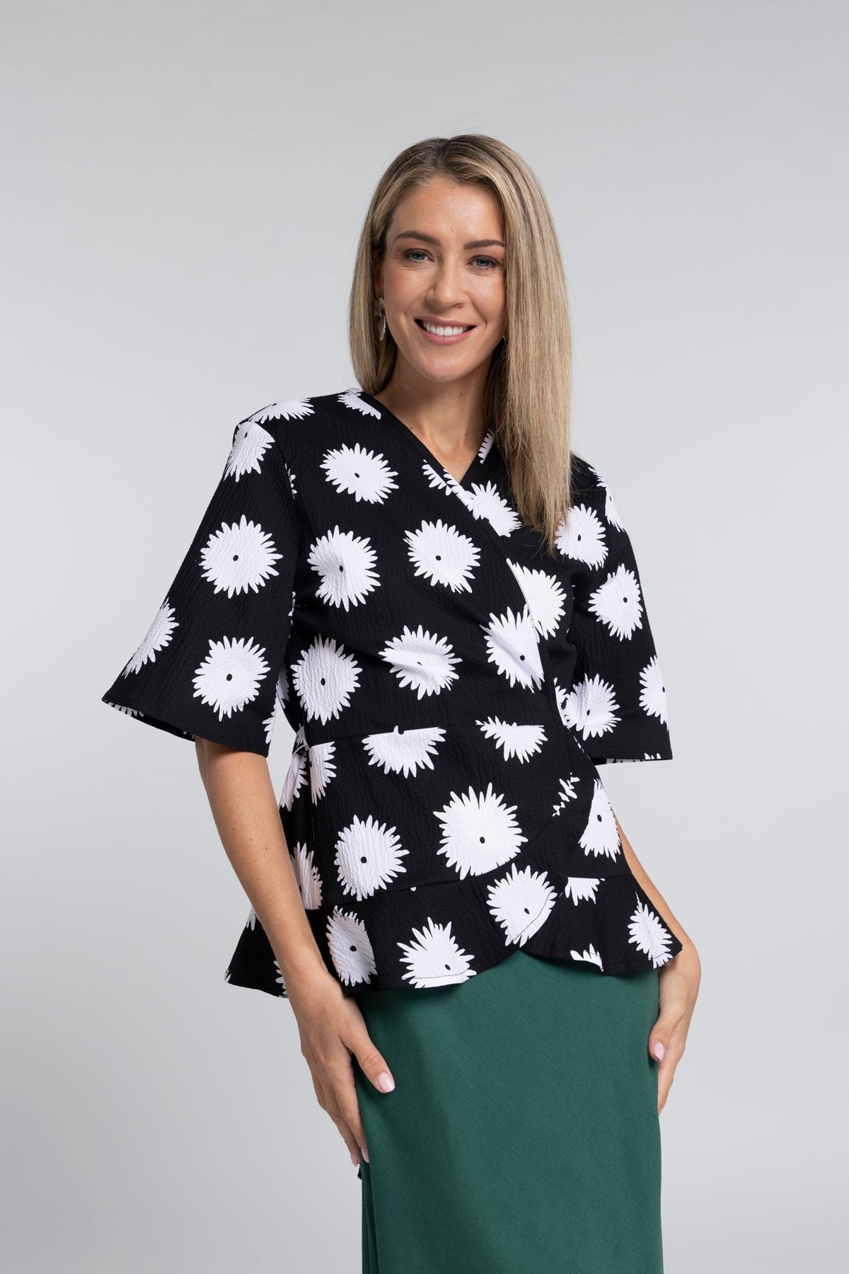 True Printed Top - Feminine Detail with a Statement Edge

A signature silhouette reimagined in print. The N-E-S True Printed Top brings together the flattering wrap shape of the True Top with our bold abstract black and white daisy print, creating a piece that feels both expressive and effortlessly wearable.

Designed and made responsibly in New Zealand