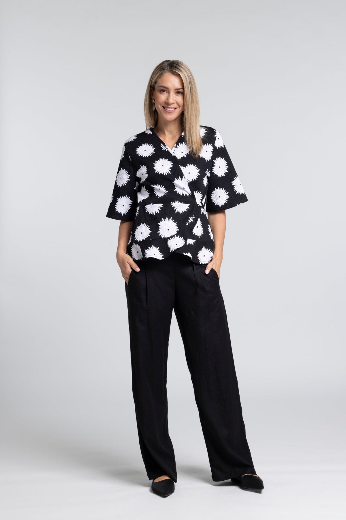 True Printed Top - Feminine Detail with a Statement Edge

A signature silhouette reimagined in print. The N-E-S True Printed Top brings together the flattering wrap shape of the True Top with our bold abstract black and white daisy print, creating a piece that feels both expressive and effortlessly wearable.

Designed and made responsibly in New Zealandc