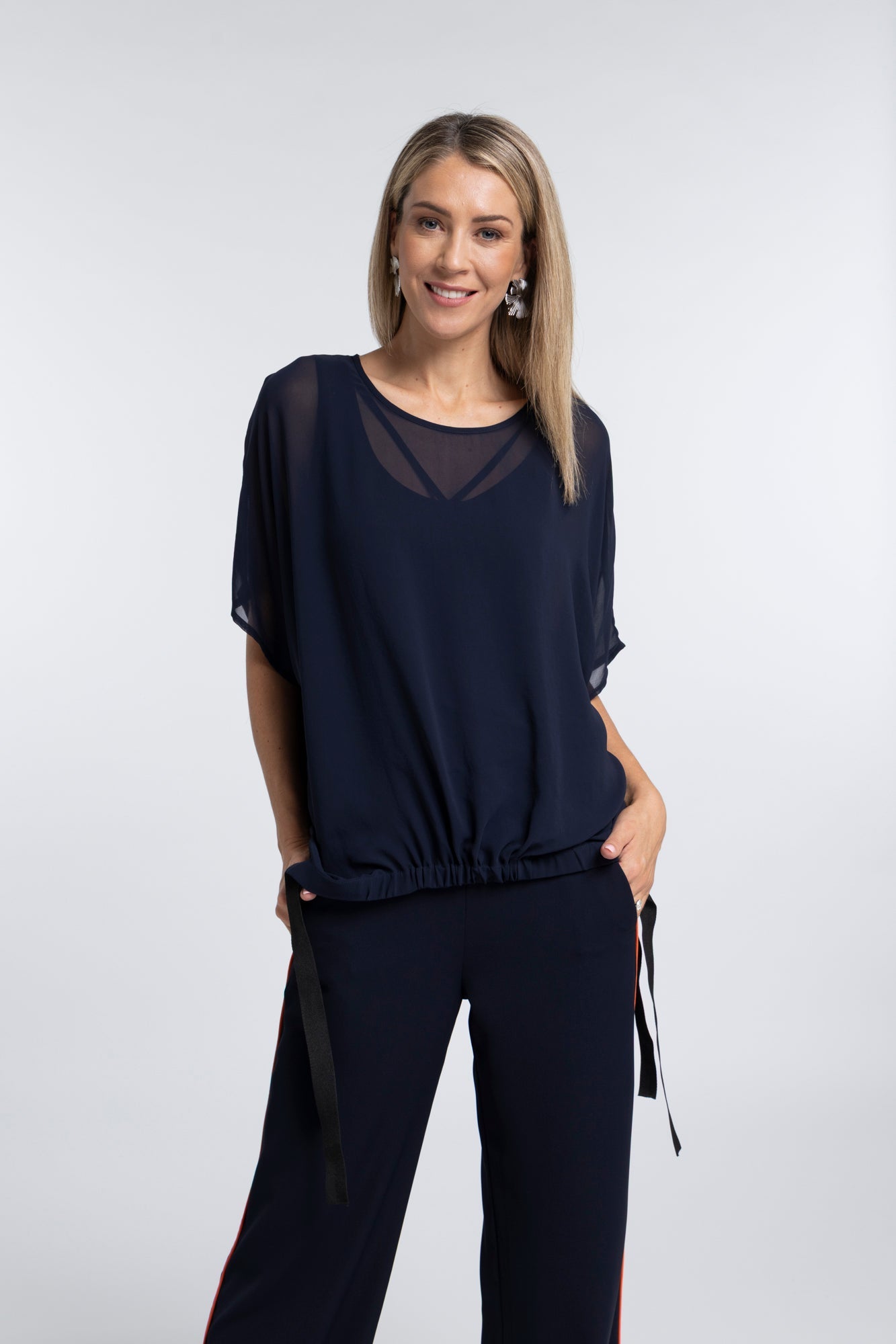 The NES Vanotti Tunic by N-E-S’ best-selling throw-on top with a scoop neckline and adjustable feature hem. Perfect over a Lattice Singlet. NZ made.