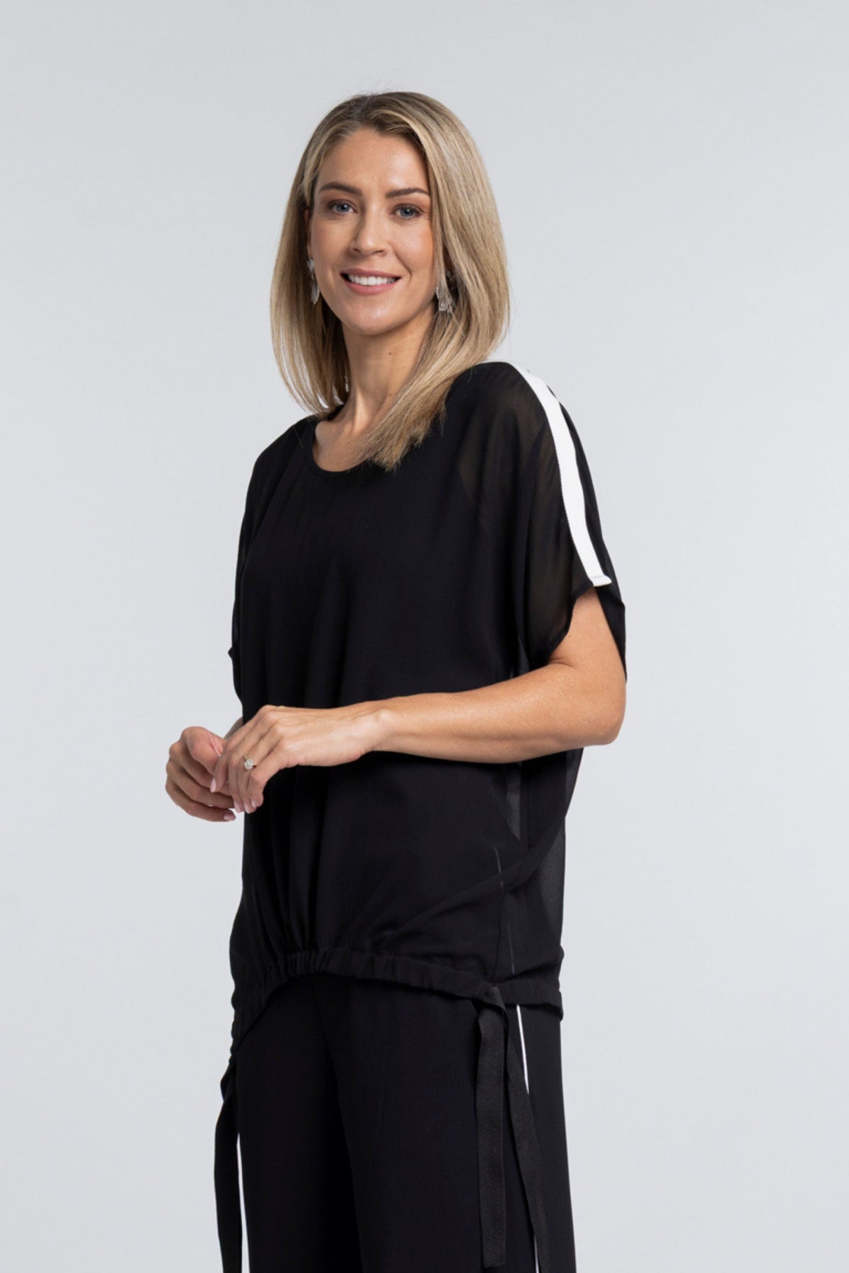 A true N-E-S icon, the Vanotti Tape Top is the piece customers return for season after season. Light, relaxed and beautifully easy to wear, it’s designed to be your effortless throw-on style for days when comfort and simplicity matter most.