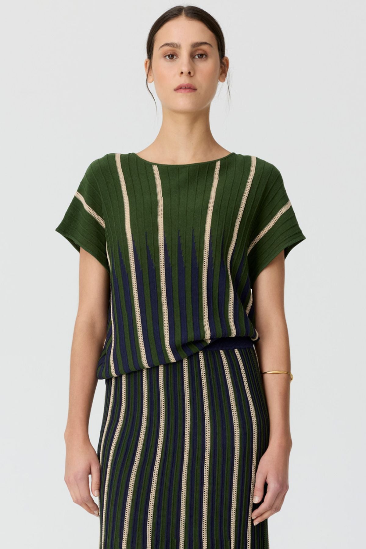 Discover the POL Axil Knit Top curated in racket, featuring signature knit pleats, pointelle contrast stripes and a relaxed, draped fit in a lightweight viscose blend.