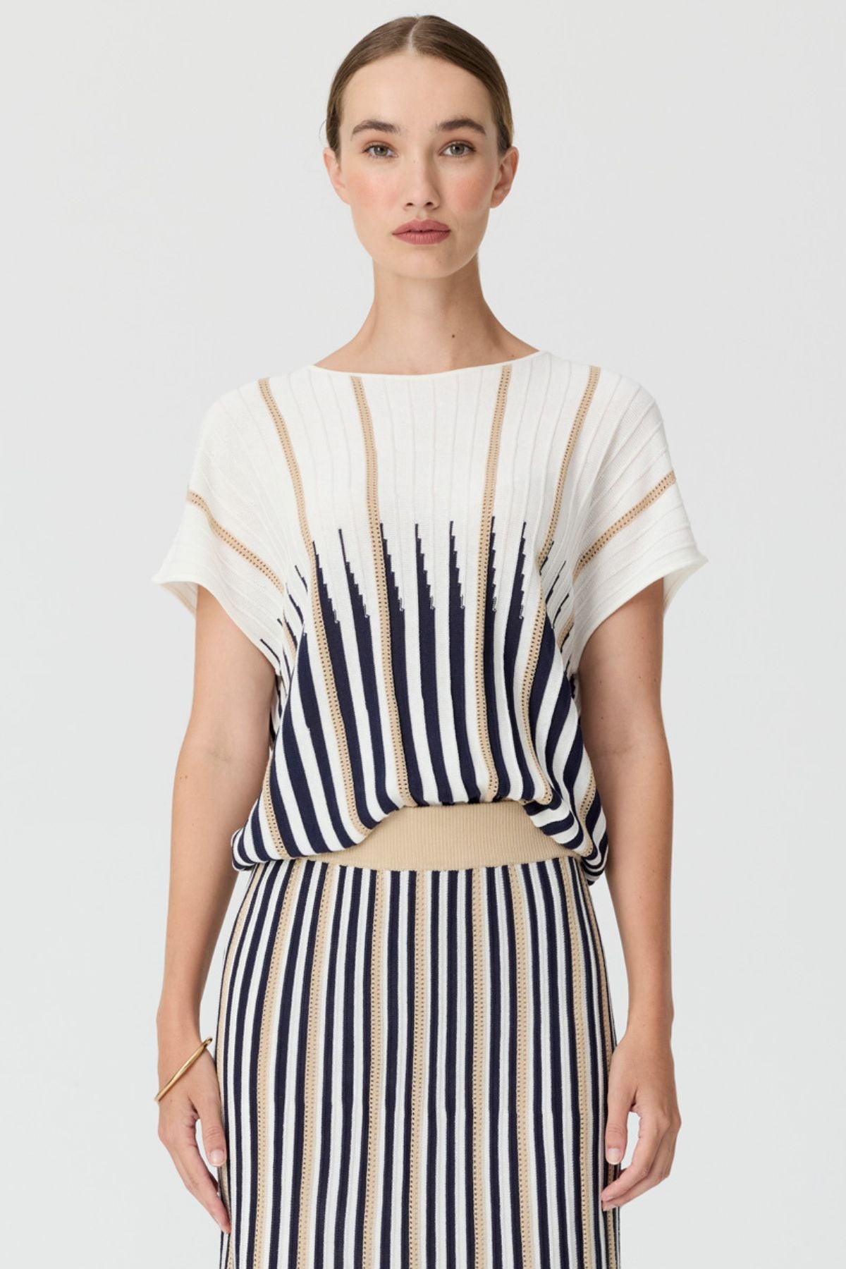 Discover the POL Axil Knit Top curated in racket, featuring signature knit pleats, pointelle contrast stripes and a relaxed, draped fit in a lightweight viscose blend.