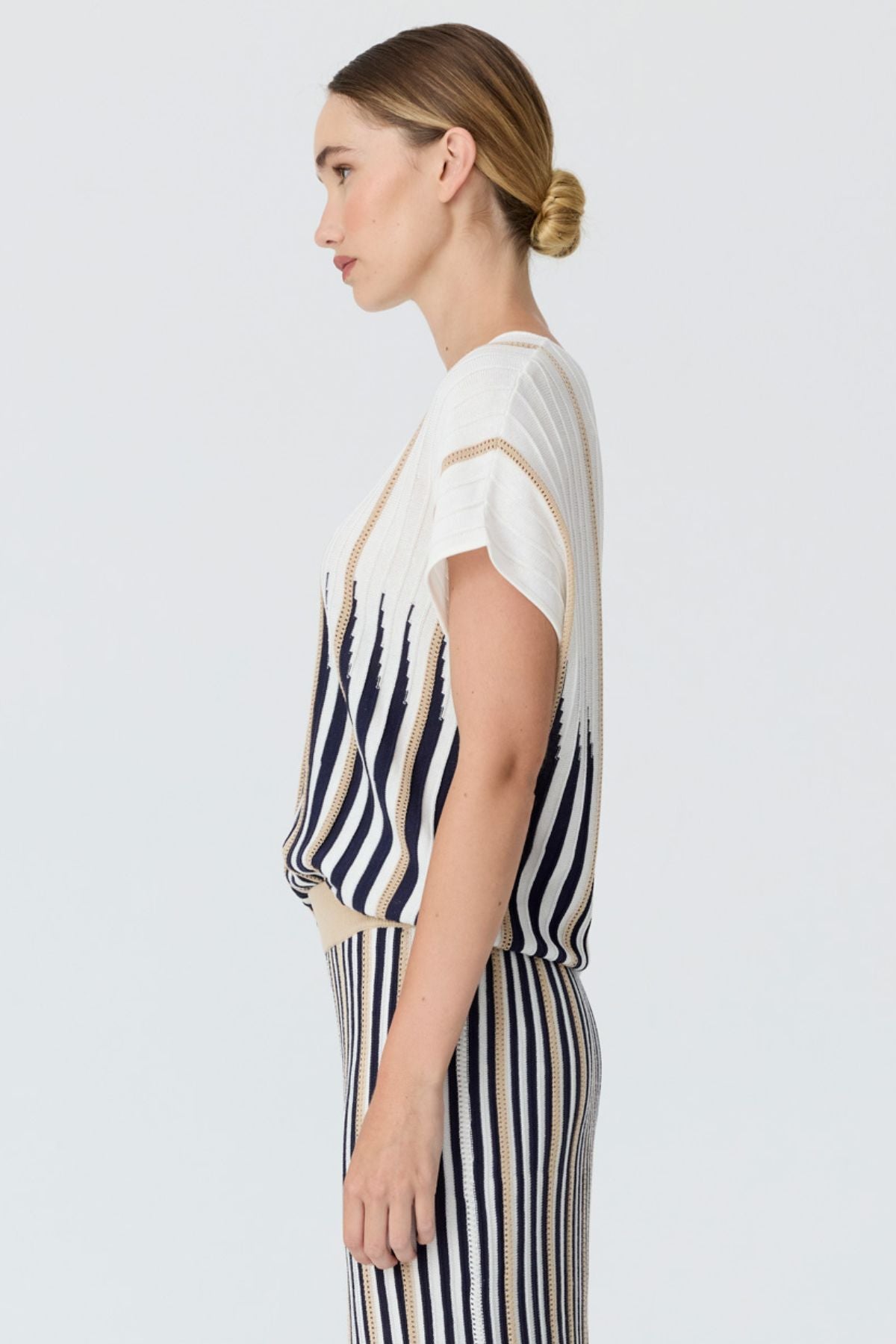 Discover the POL Axil Knit Top curated in racket, featuring signature knit pleats, pointelle contrast stripes and a relaxed, draped fit in a lightweight viscose blend.