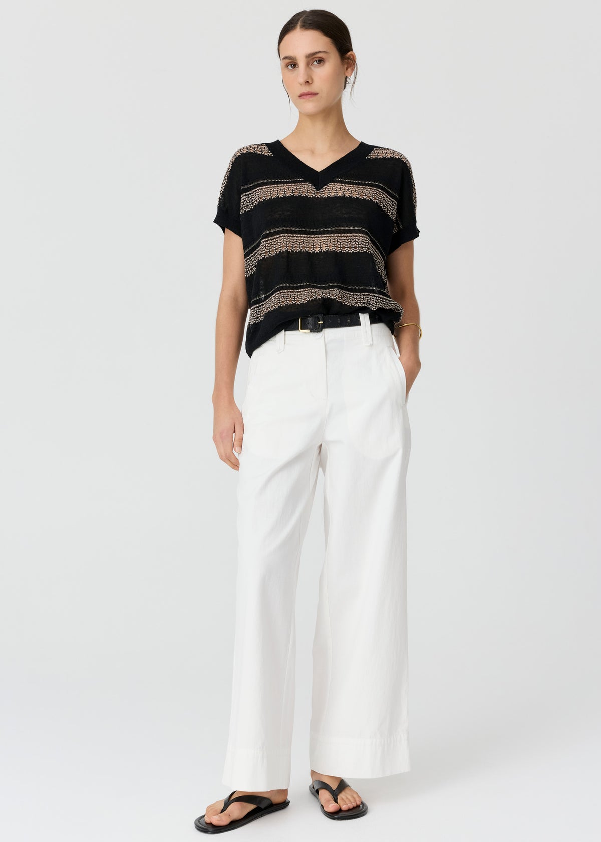 Shop the POL Liana V-Neck Pointelle Knit - a 100% cotton oversized knit with intricate pointelle stripes, semi-sheer detailing and a relaxed longline silhouette.