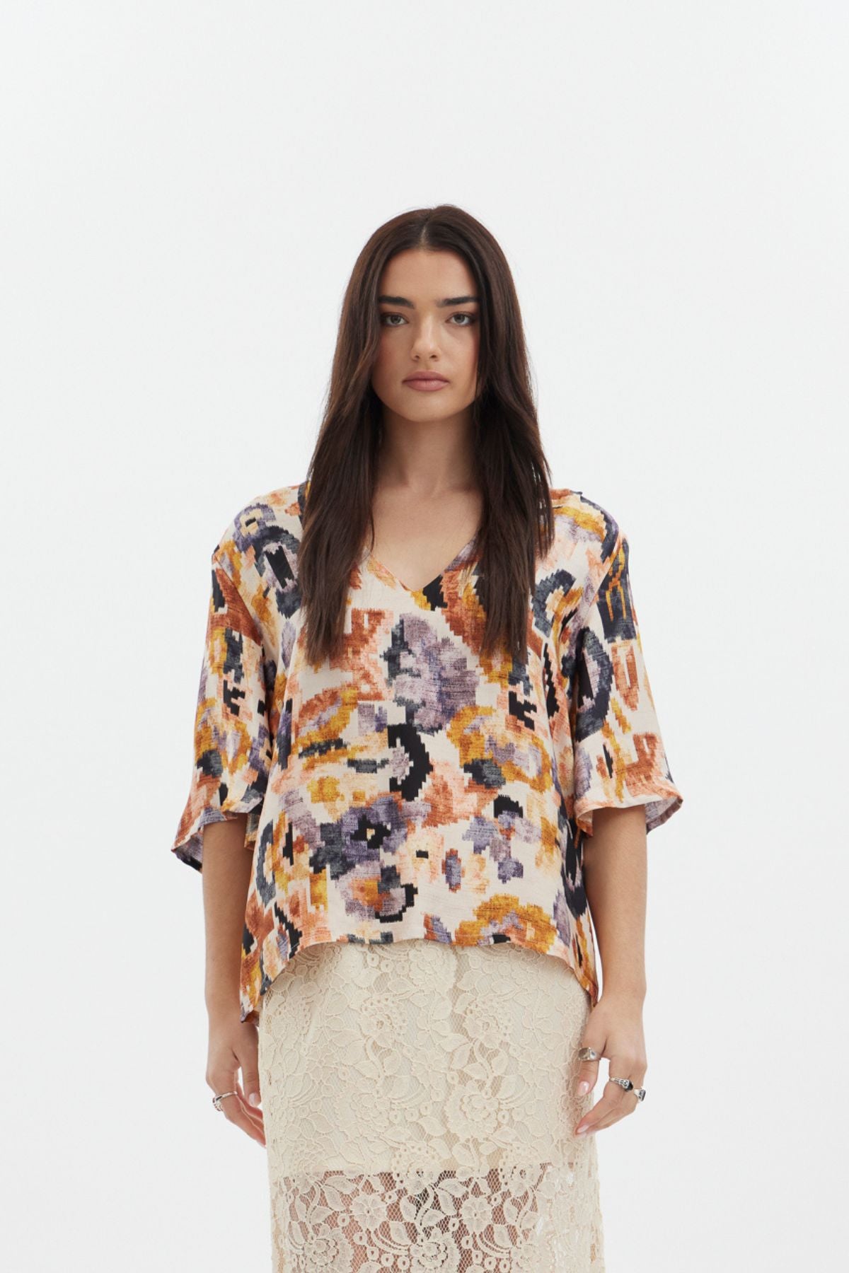 The Dylan Top by racket - a reversible crew and V-neck top in an Aztec-inspired rayon satin print with floaty sleeves. Designed and made in NZ.