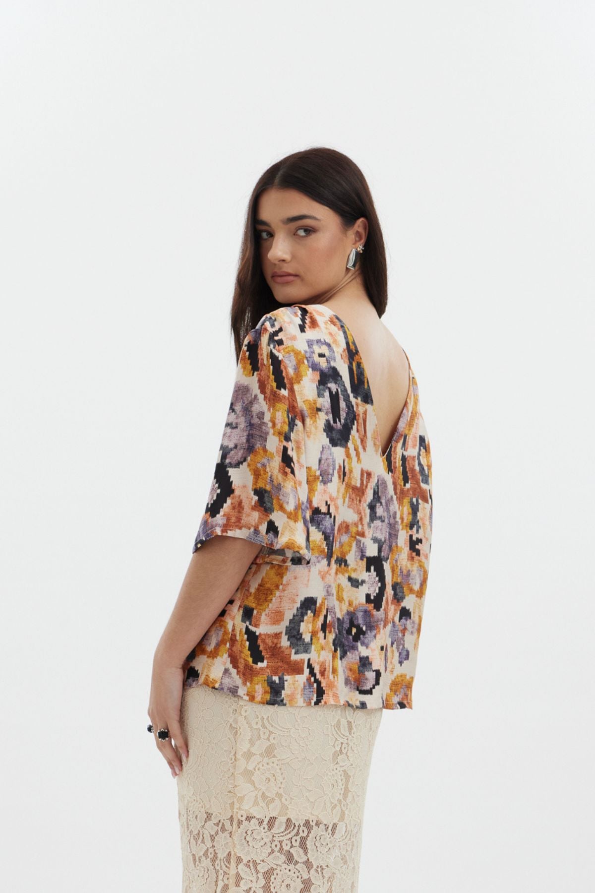 The Dylan Top by racket - a reversible crew and V-neck top in an Aztec-inspired rayon satin print with floaty sleeves. Designed and made in NZ.