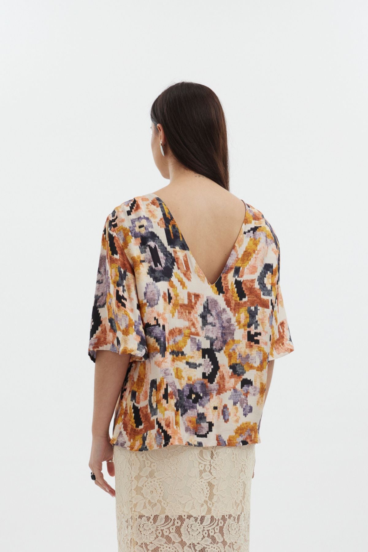 The Dylan Top by racket - a reversible crew and V-neck top in an Aztec-inspired rayon satin print with floaty sleeves. Designed and made in NZ.
