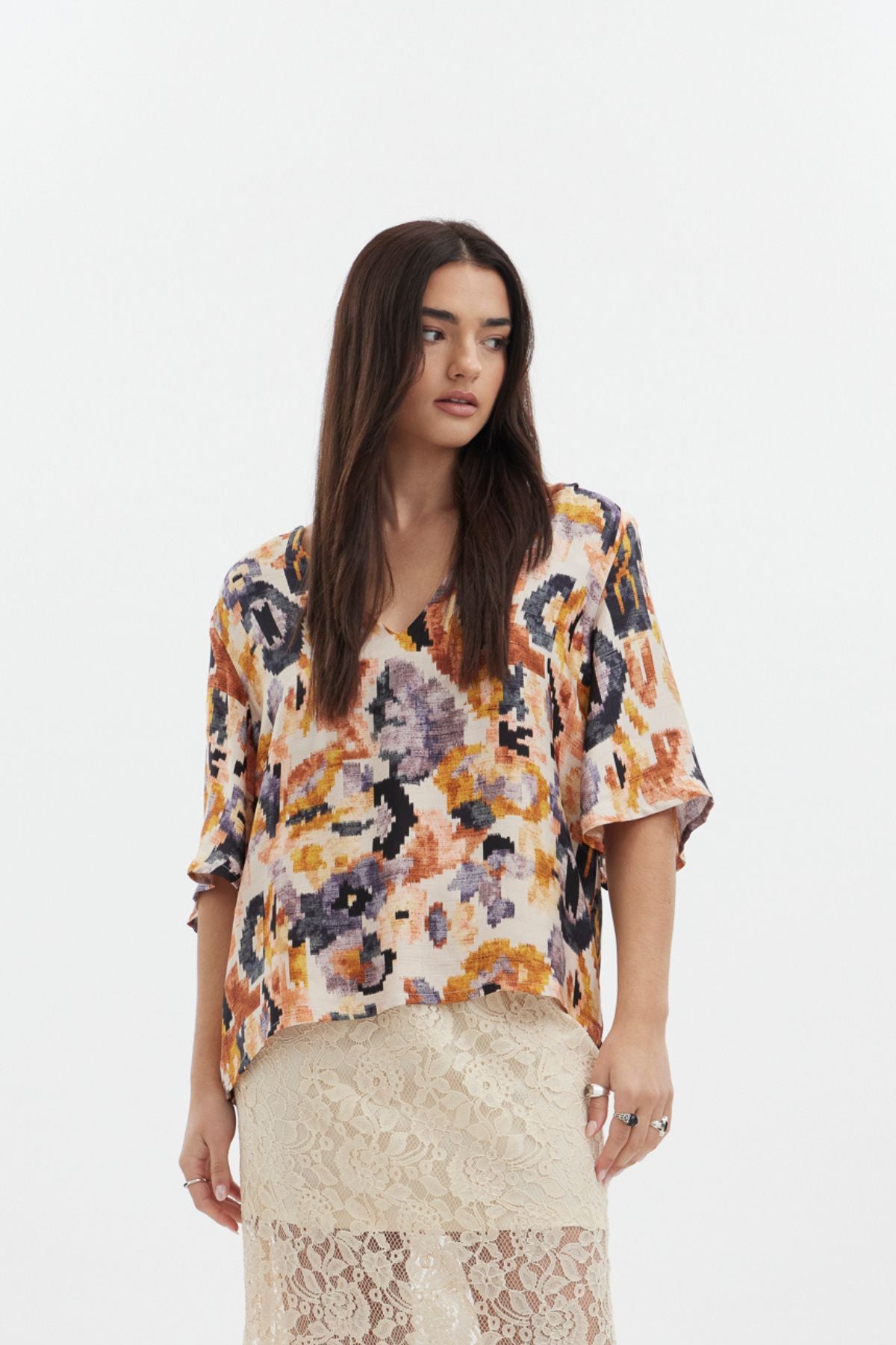 The Dylan Top by racket - a reversible crew and V-neck top in an Aztec-inspired rayon satin print with floaty sleeves. Designed and made in NZ.