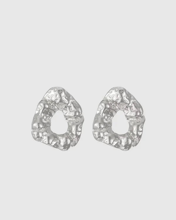 Modern and sculptural, the Castel & Co Remi Earrings in polished silver feature an open, organic form with a textured finish. Their irregular shape adds depth and edge, while the cool silver tone brings a sleek, contemporary feel. A striking statement stud that balances artistry with everyday versatility.

Material: Stainless steel
Closure Type: Stud
Earring Size: 3 x 2.4 cm
Waterproof and hypoallergenic
Weight: 8g
