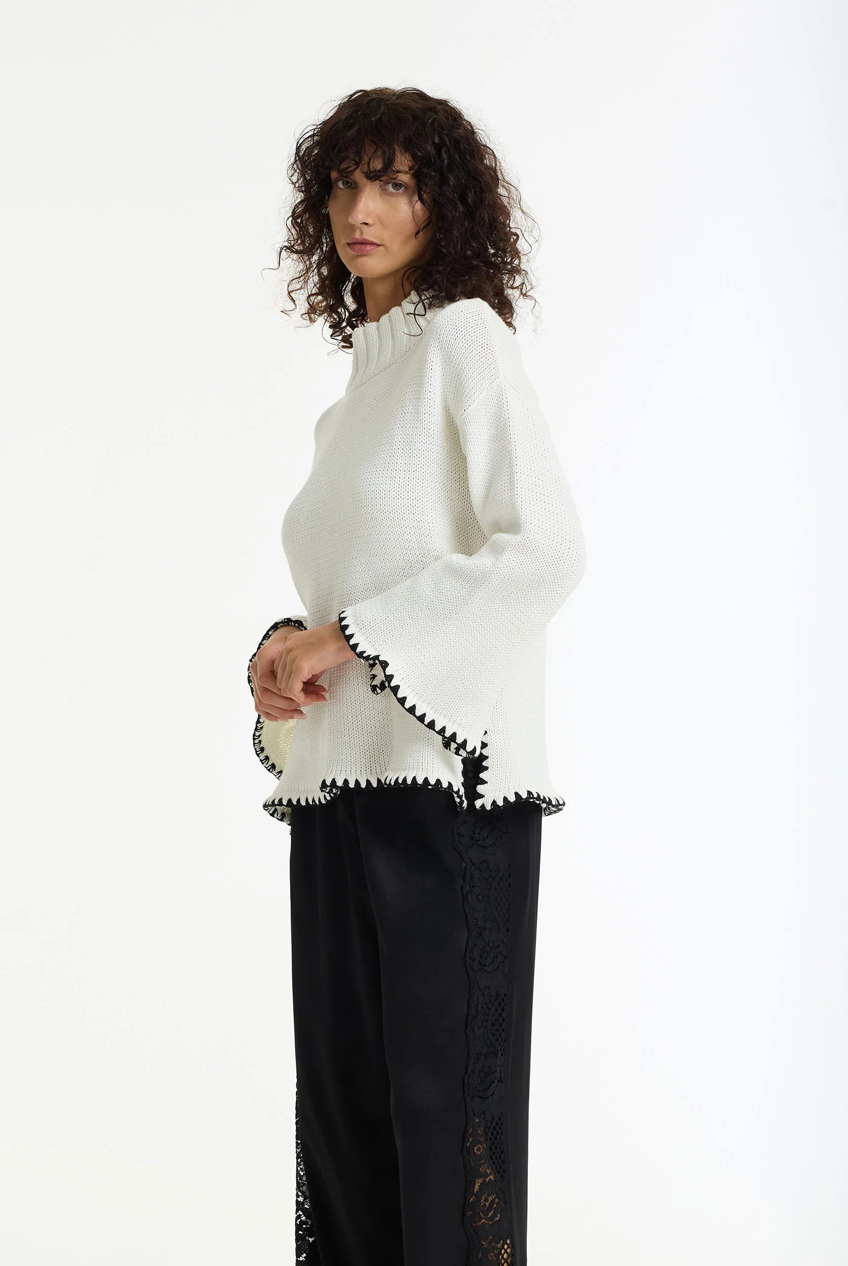 BLAK : The Vogue Cotton Sweater is a white cotton knit designed with black contrast stitching, wide sleeves and a relaxed, easy silhouette. Knitted from breathable cotton yarn, it has a soft mid-weight feel that makes it perfect for effortless layering across seasons. 