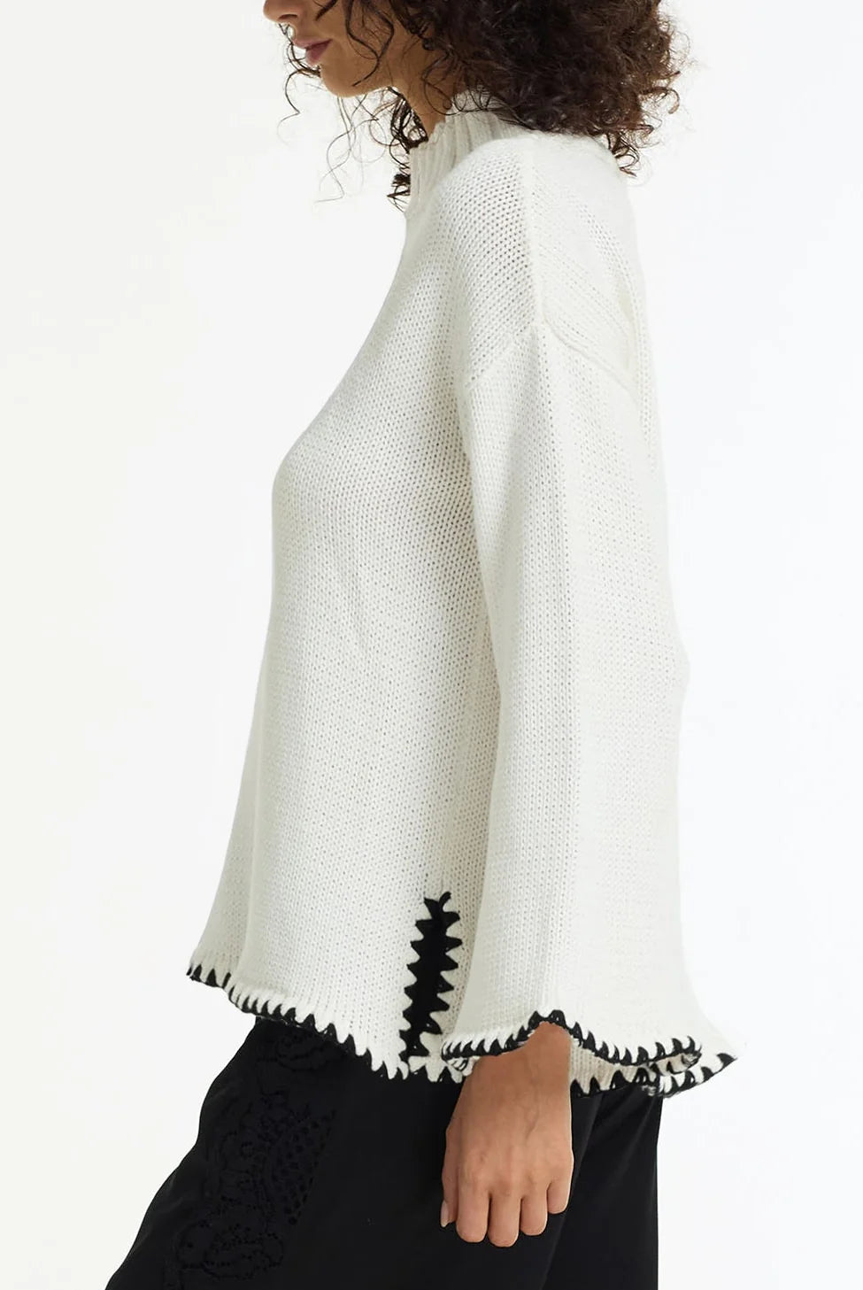 BLAK : The Vogue Cotton Sweater is a white cotton knit designed with black contrast stitching, wide sleeves and a relaxed, easy silhouette. Knitted from breathable cotton yarn, it has a soft mid-weight feel that makes it perfect for effortless layering across seasons. 