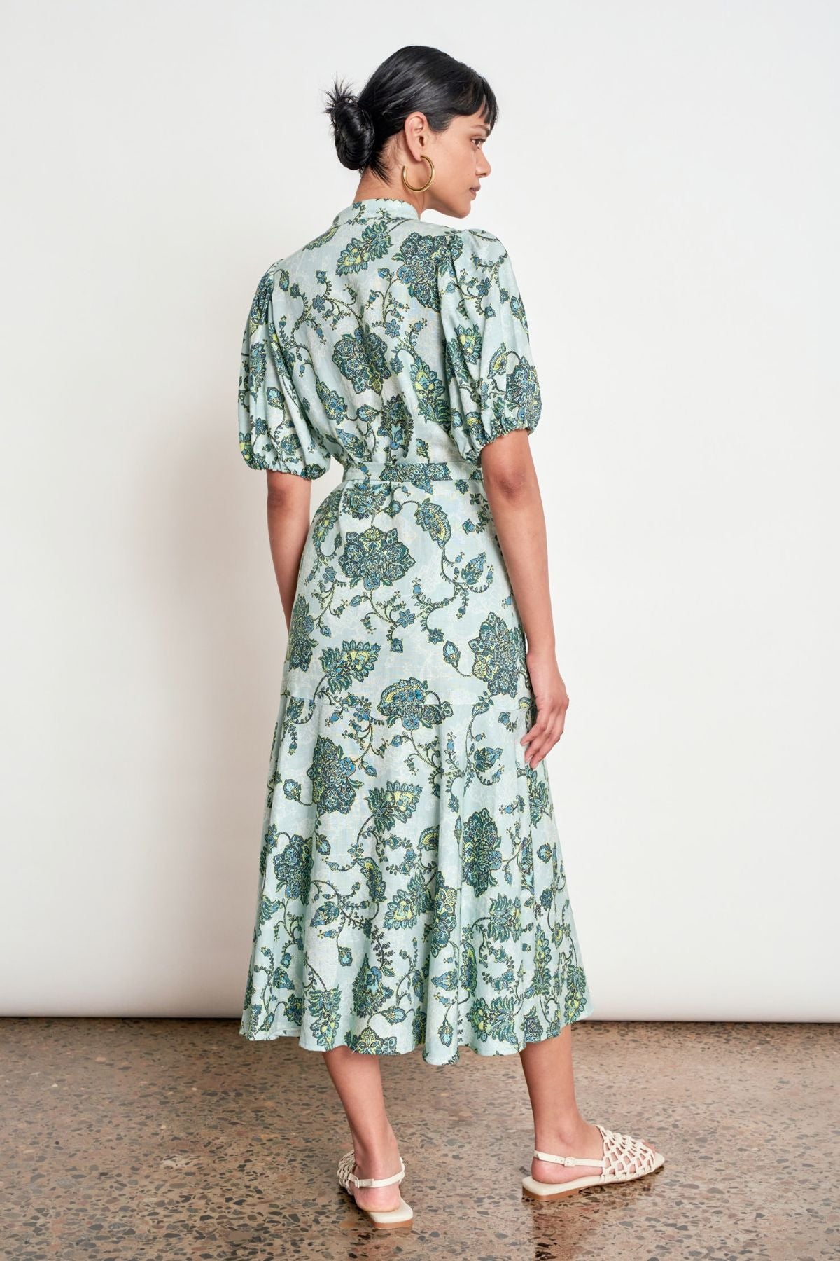 Discover the Zoe Kratzmann Cascade Dress in Fern Paisley. Crafted from 100% linen with antique brass buttons, gathered sleeves and a relaxed midi silhouette.