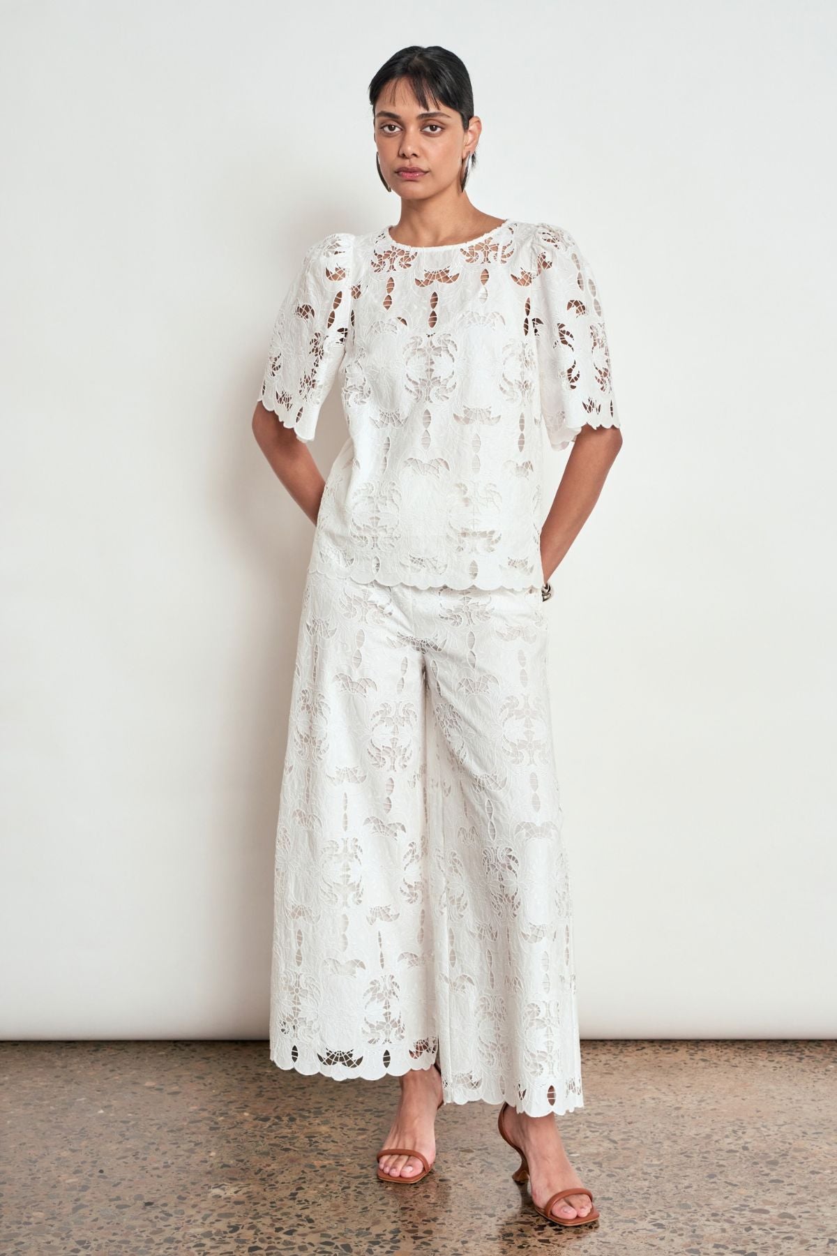 Discover the Zoe Kratzmann Resolve Top in Alabaster. Crafted from intricate 100% cotton lace with gathered short sleeves, a classic round neckline and cami included.
