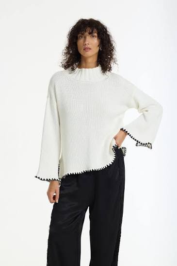BLAK : The Vogue Cotton Sweater is a white cotton knit designed with black contrast stitching, wide sleeves and a relaxed, easy silhouette. Knitted from breathable cotton yarn, it has a soft mid-weight feel that makes it perfect for effortless layering across seasons. 