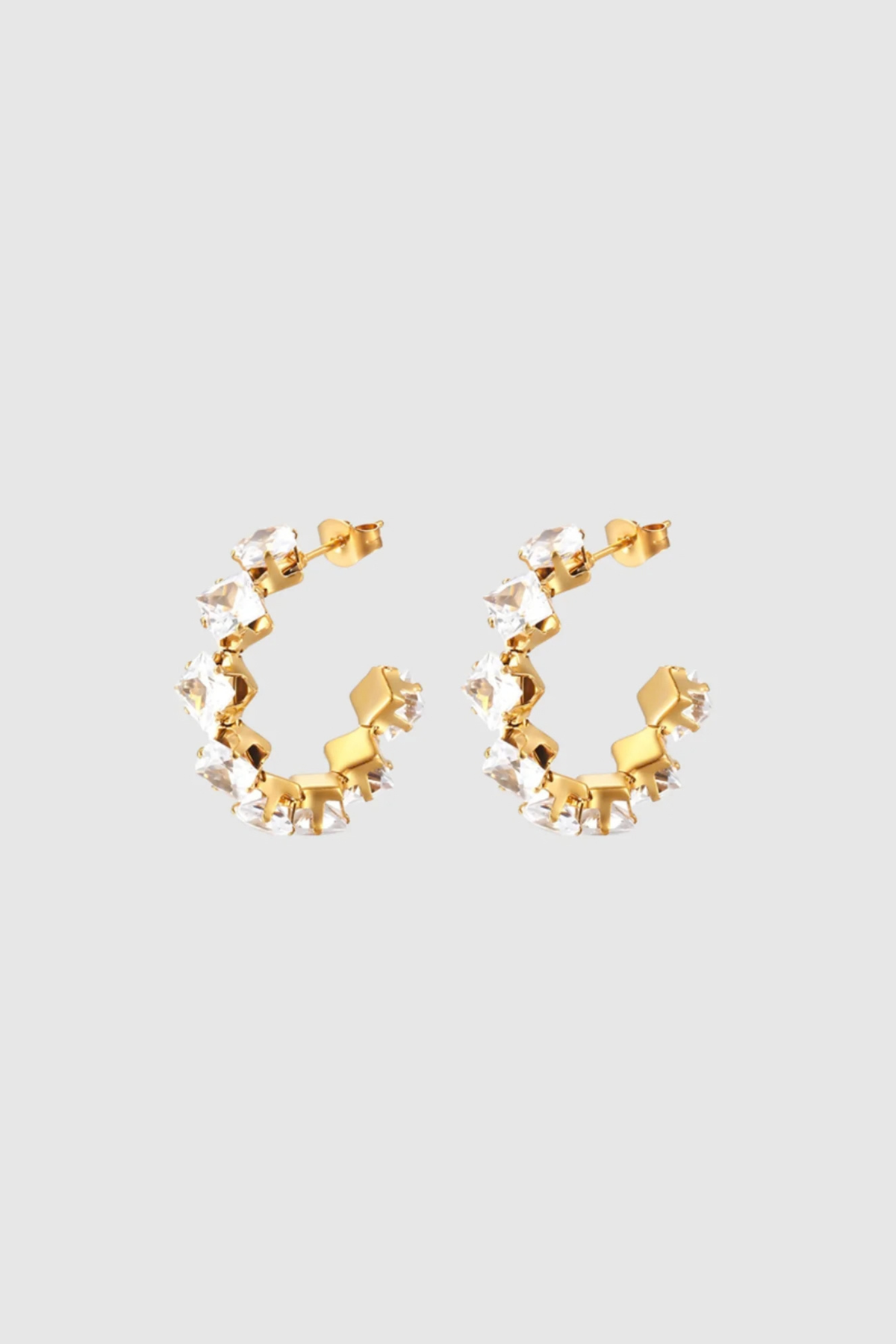 Radiant and refined, the Freya Hoops feature gold-plated bands set with sparkling cubic zirconia. Their circular silhouette offers just the right amount of drama, catching the light beautifully from every angle. A modern statement hoop that pairs timeless elegance with contemporary shine.