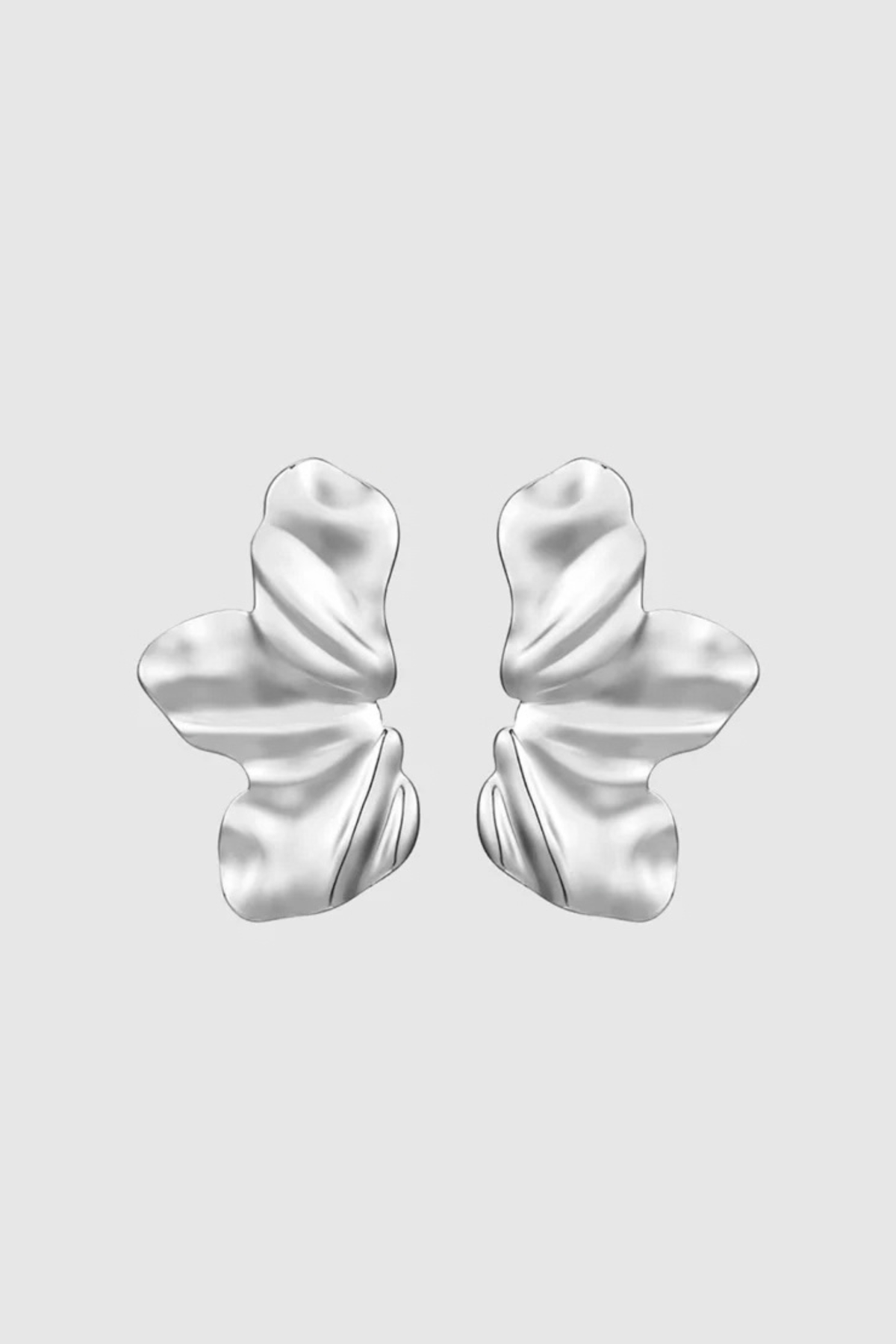 Sculptural and dramatic, the Castel & Co Sienna Earrings feature fluid, folded curves in radiant gold plating. Their bold silhouette and organic form create a striking sense of movement, designed to frame the face with modern artistry. A statement earring that embodies elegance with an edge.

Material: Stainless steel, Gold plating
Closure Type: Stud
Earrings Size: 4.5 x 2.5 cm
Waterproof and hypoallergenic
Weight: 7g