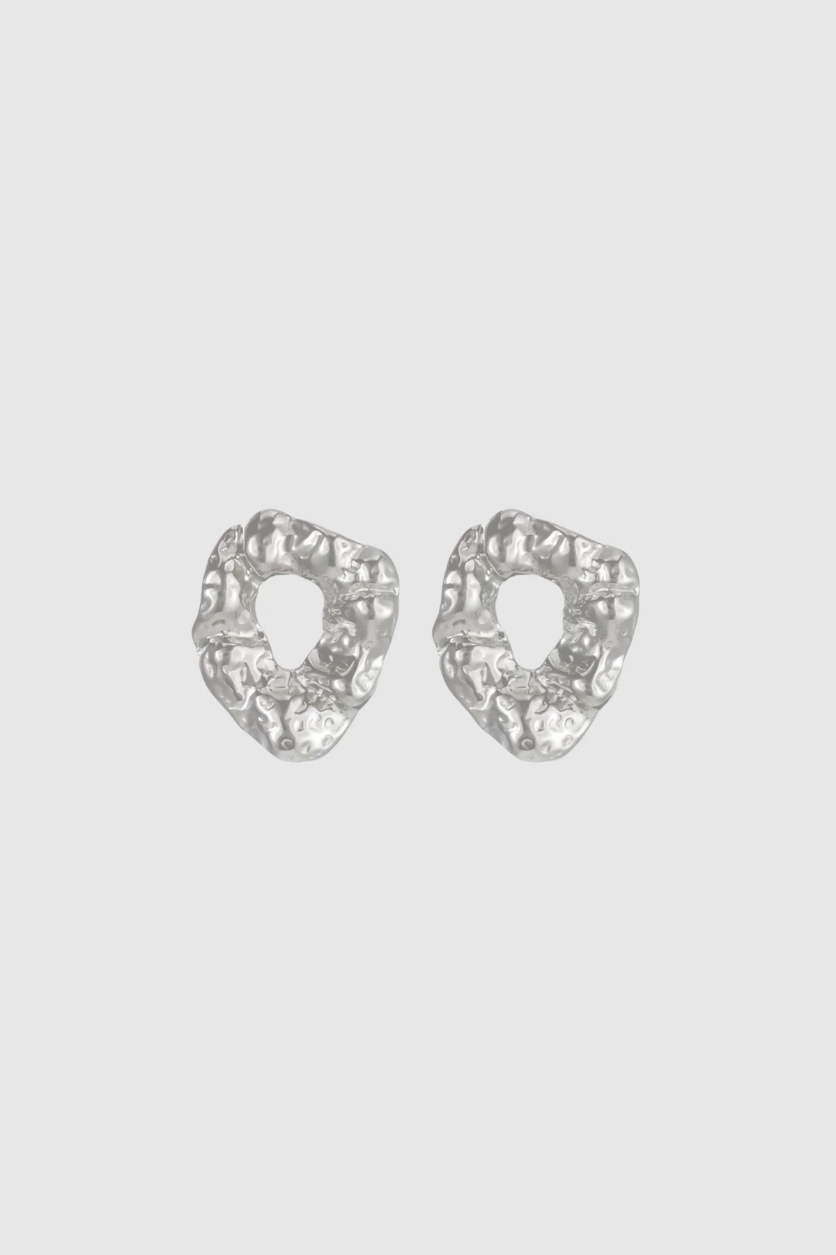 Modern and sculptural, the Castel & Co Remi Earrings in polished silver feature an open, organic form with a textured finish. Their irregular shape adds depth and edge, while the cool silver tone brings a sleek, contemporary feel. A striking statement stud that balances artistry with everyday versatility.

Material: Stainless steel
Closure Type: Stud
Earring Size: 3 x 2.4 cm
Waterproof and hypoallergenic
Weight: 8g