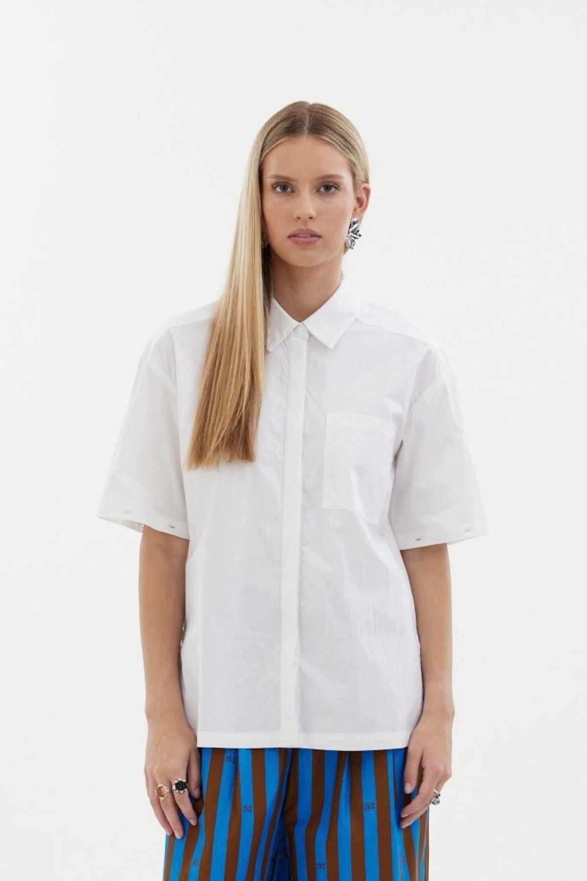 The Rebel Shirt by Racket - a two-in-one shirt with button off sleeves, boxy fit and refined detailing. Available in RKT stripe, white or black. NZ made.