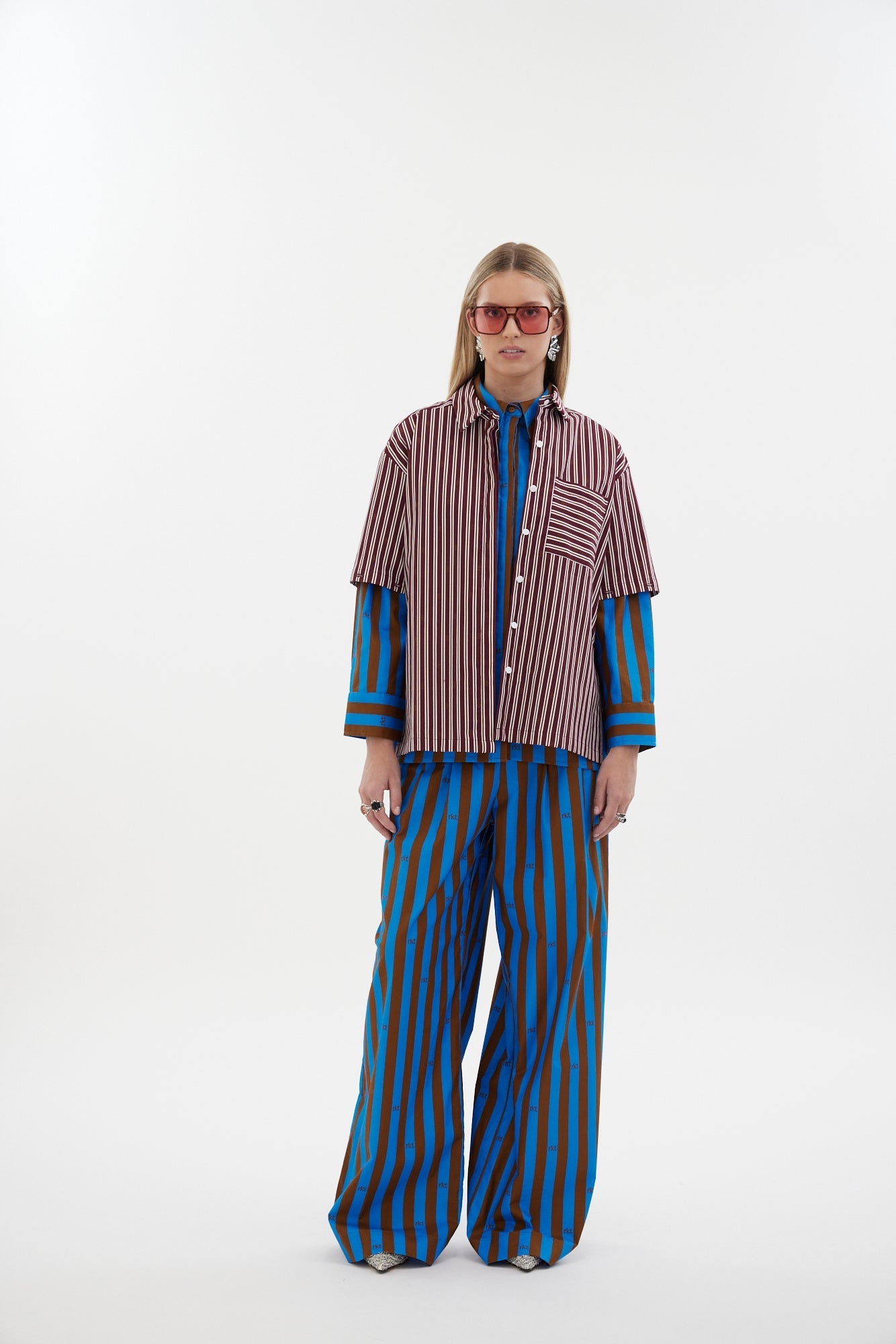 The Icon Shirt by Racket - a relaxed stripe shirt with concealed placket, back yoke pleats and stepped hem. Includes exclusive RKT logo stripe. Made in NZ.
