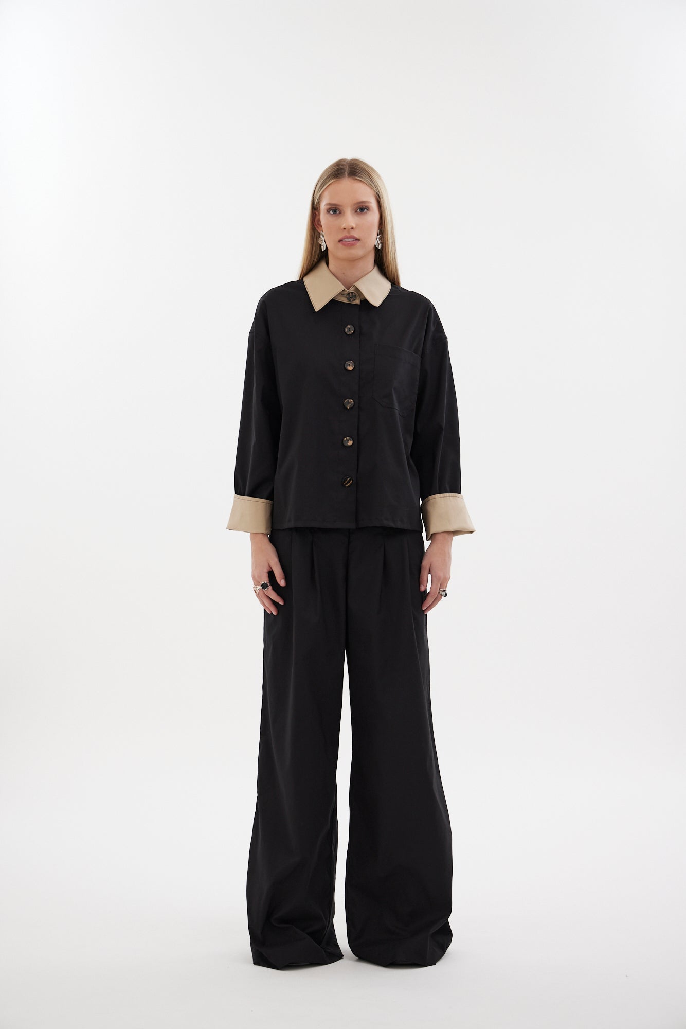 The Motion Pant by Racket — a wide leg cotton pant with double pleats and flexible comfort. Available in black or latte and two inseam lengths. NZ Made.