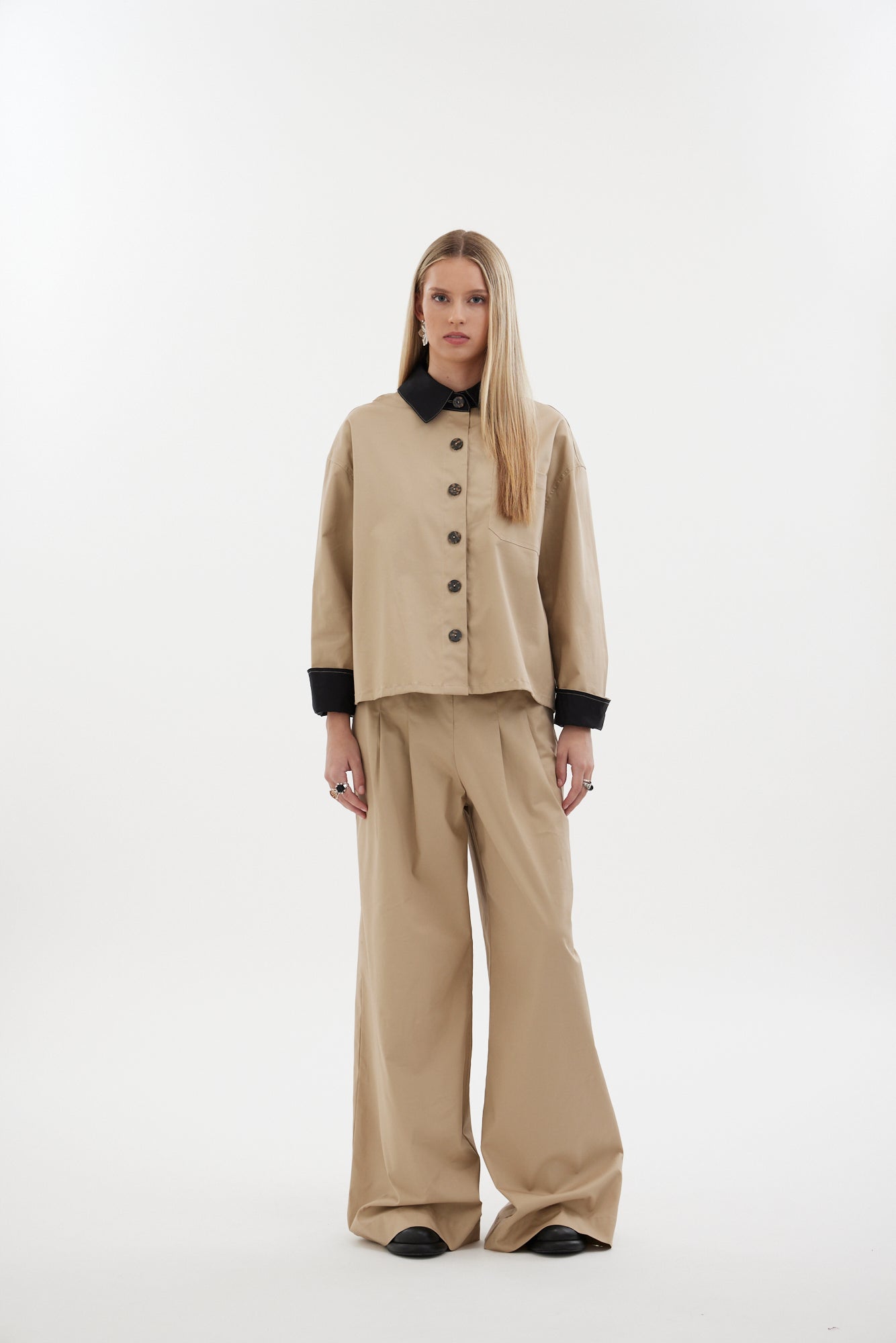The Motion Pant by Racket — a wide leg cotton pant with double pleats and flexible comfort. Available in black or latte and two inseam lengths. NZ Made.