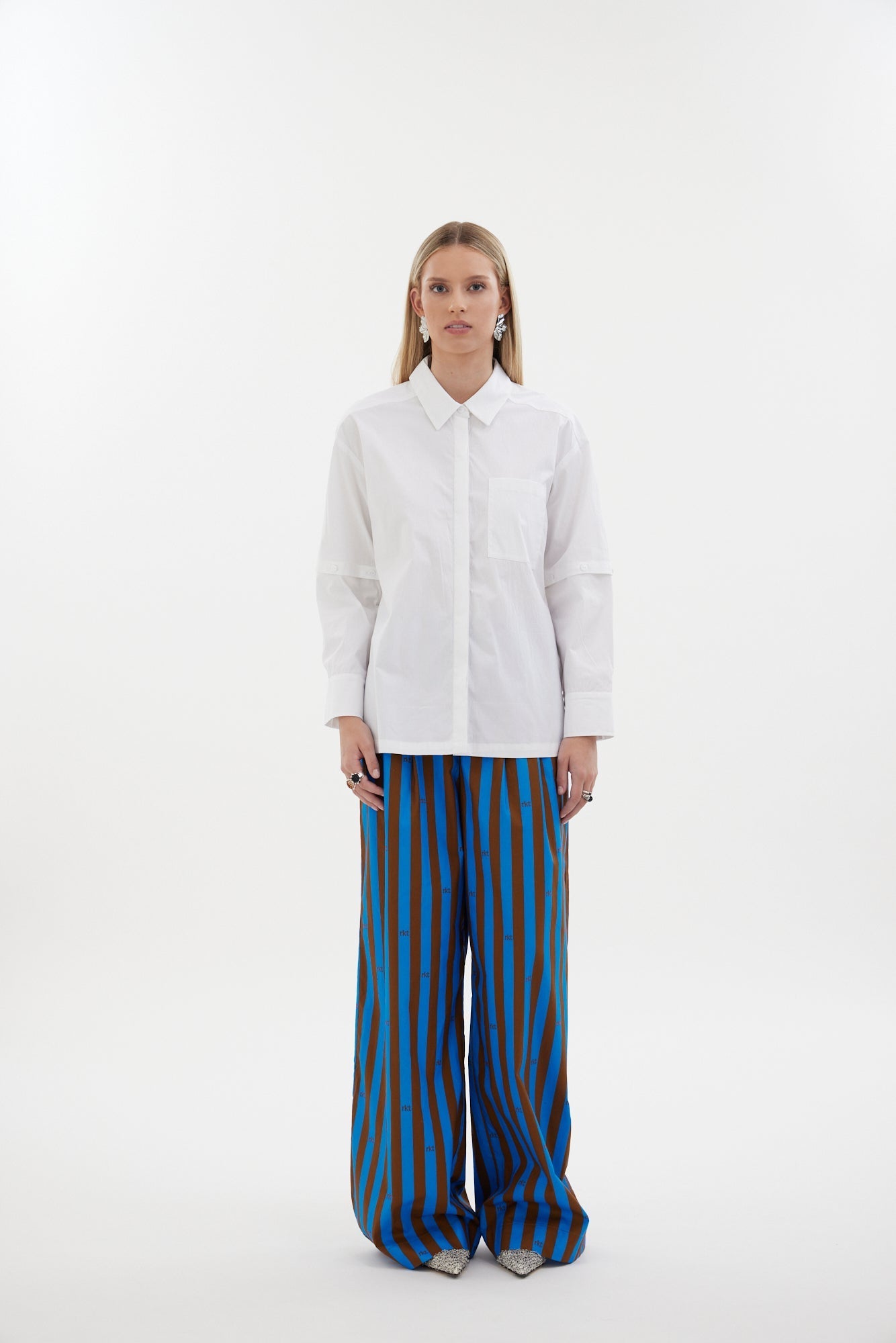 The Rebel Shirt by Racket - a two-in-one shirt with button off sleeves, boxy fit and refined detailing. Available in RKT stripe, white or black. NZ made.