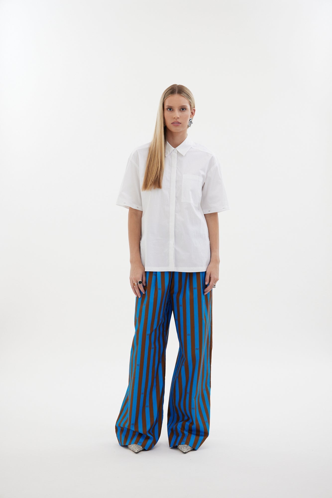 The Rebel Shirt by Racket - a two-in-one shirt with button off sleeves, boxy fit and refined detailing. Available in RKT stripe, white or black. NZ made.